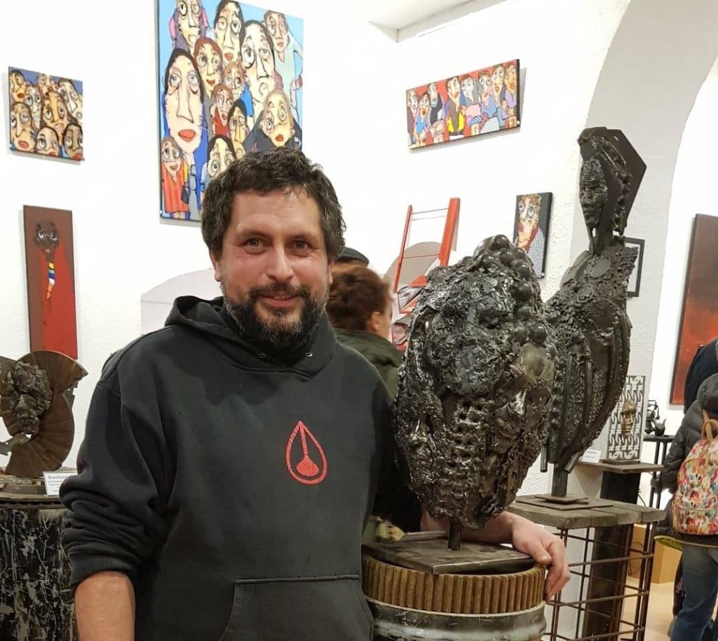 Romain Bresson, sculpteur métal, auprès de l'une de ses sculptures en métal récupéré